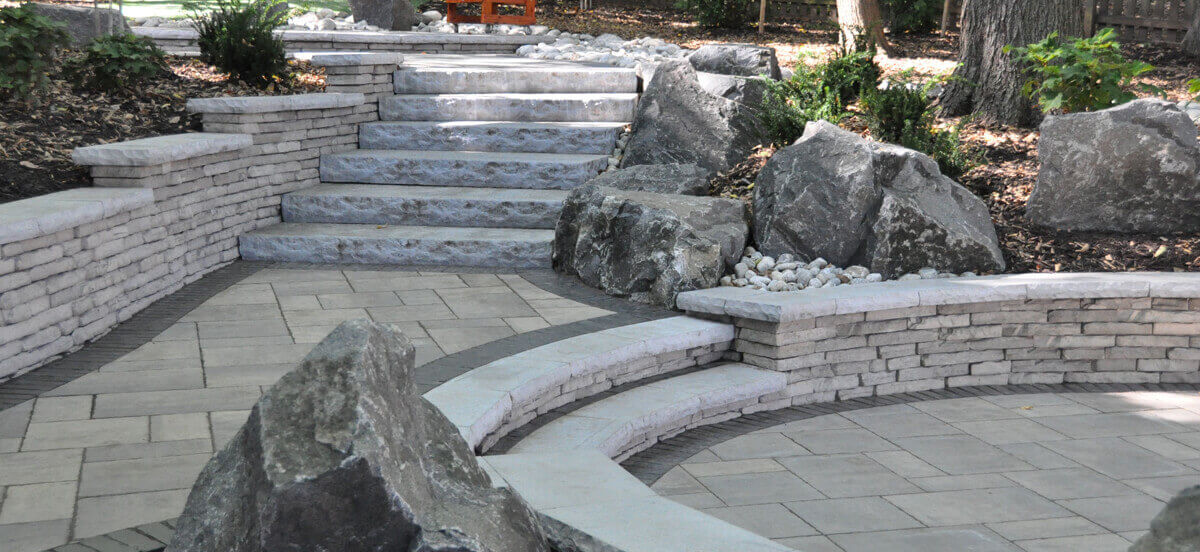 Stone steps in backyard area for residential landscape design.