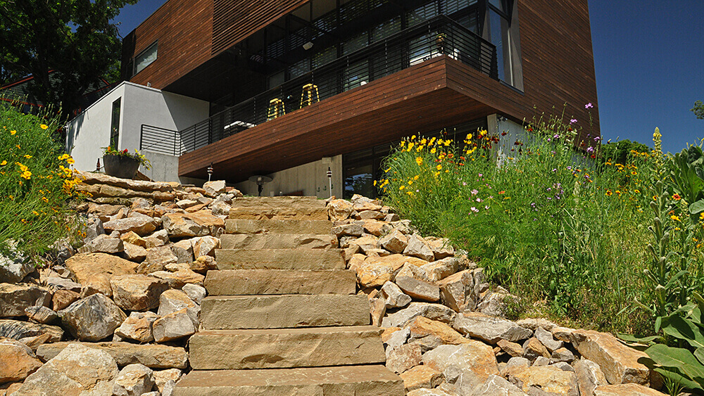 Balcony overlooking stone steps and rocks.