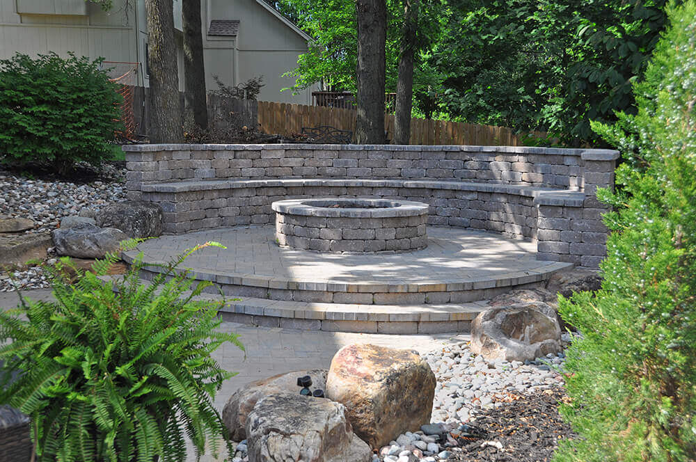 built-in stone seating area with fire pit