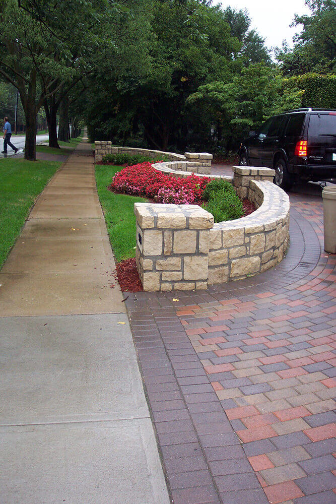 Paved area with limestone entrance.