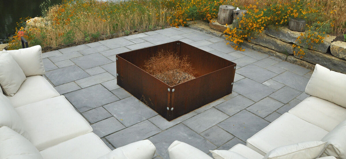 Outdoor living area with firepit and seating area, completed by Embassy Landscape Group.