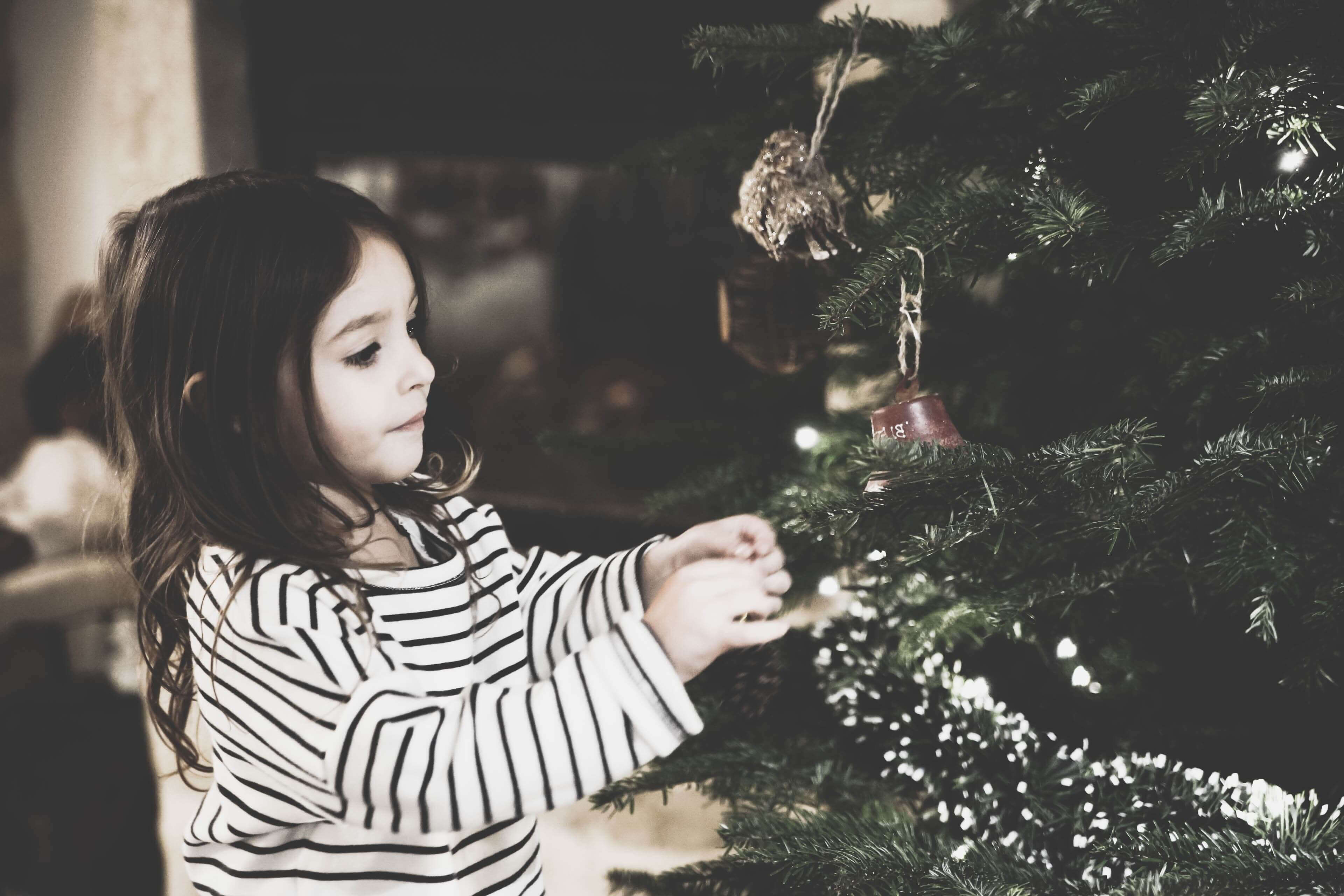 girl hanging ornament